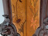 a wooden vase with a floral design on it