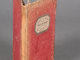 a small red book with a white label on it