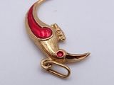an image of a gold and red broochle