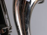 a close up of a saxophone with a note on it
