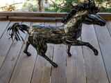 a statue of a horse that is standing on a porch