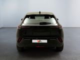 the rear end of a black car in a white room