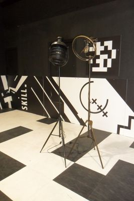 a black and white room with a black and white checkered floor and a black and white wall