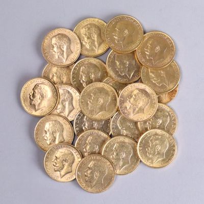 a pile of gold coins sitting on a white surface