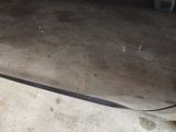 a skateboard that is laying on the ground in the garage