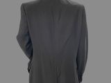 the back view of a mannequin wearing a suit and tie