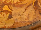 a close up of a wooden table with flowers and leaves on it