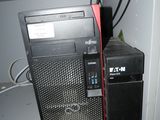 a computer that is sitting on top of a shelf