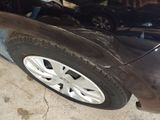a close up of a black car with a flat tire