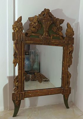 a mirror that is sitting on a shelf in the corner of a room