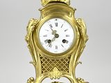 a gold clock that is sitting on a table