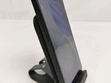 a phone that is sitting on a stand on the table