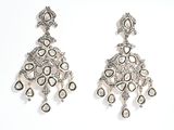 two pairs of diamond and white gold earrings on a white background
