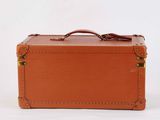 a brown suitcase sitting on a white surface