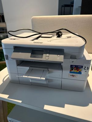 a white printer sitting on top of a white table