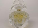 clear glass perfume bottle with a yellow flower on top