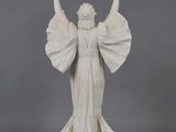 statue of a woman holding a bird in her right hand