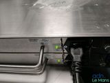 a silver oven with a metal tray on top of it