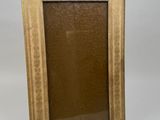an old picture frame sitting on a white surface with a white background