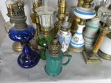 many different types of glass lamps on the table