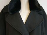 the coat is black and has a fur collar on it