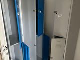 two lockers in the corner of a room with blue doors