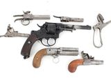 several different types of guns and pliers on a white surface