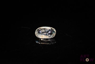 a close up of a diamond on a black surface