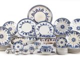 a large group of blue and white plates and bowls