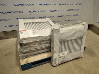 une pile de cartons posée sur une palette, près d'un mur