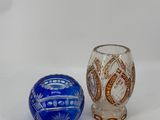 two vases sitting next to each other on a white surface