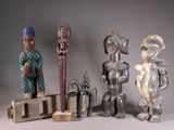 several different types of african figurines are displayed on a table