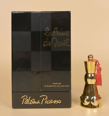 perfume bottle and box of perfume sitting on a table with a box of perfume in the background