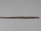 a small knife with a wooden handle on a gray surface