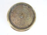 a close up of a gold plate on a white surface