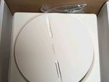 a white electronic device in a box on a table