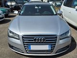 a silver audi parked in a parking lot with other cars in the background