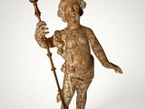 an antique statue of a boy holding a torch in his hand