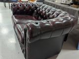 a brown leather couch and chair in a store
