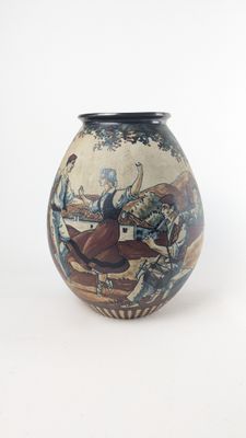 a vase that has a painting on it on it
