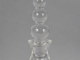 a close up of a clear glass bottle with a glass stopper