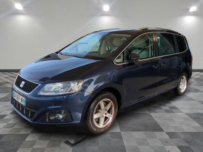 the blue van is parked on a checkered floor in a garage