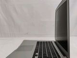 an open laptop computer sitting on top of a white table