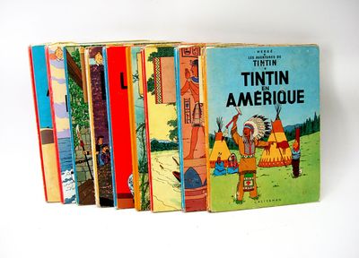 several children ' s books are lined up on a white surface