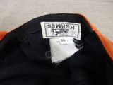 an orange and black jacket with a label that says hebwe ' s