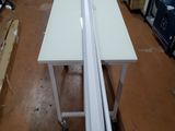 a picture of a white table in a warehouse