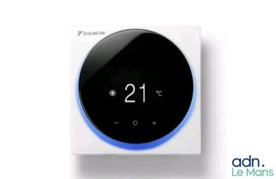 a white and blue smart thermosta sitting on top of a white box