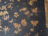 a black table with gold flowers on it