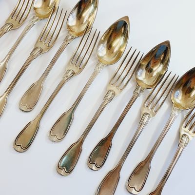 a lot of silver spoons and forks on the table