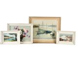 four framed pictures of boats and a vase of flowers
